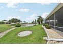 A meticulously maintained backyard with a beautiful view of the serene community pond at 2306 Emerald Lake Dr, Sun City Center, FL 33573