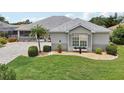 Charming house with a well-manicured lawn, decorative shutters, and colorful flower box at 2306 Emerald Lake Dr, Sun City Center, FL 33573