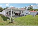 Covered patio with seating, great lawn and a garden shed at 2650 60Th N Ave, St Petersburg, FL 33714