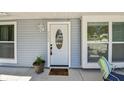 Inviting entryway featuring a white front door with glass, and charming welcome mat at 2692 Cedarbrooke Dr, Palm Harbor, FL 34684