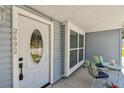 Cozy covered front porch with a seating area to enjoy the outdoors and neighborhood at 2692 Cedarbrooke Dr, Palm Harbor, FL 34684