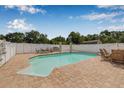 Backyard pool featuring classic columns and a well maintained deck for entertaining at 30703 San An Rd, San Antonio, FL 33576