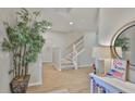Bright foyer with a staircase, wood-look floors, neutral walls and attractive decorations at 314 Blackrock Ln, Apollo Beach, FL 33572
