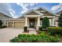 Charming single Gathering house featuring manicured front yard and stone details on the columns at 4222 Glade Wood Loop, New Port Richey, FL 34655