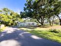 Spacious property with mature trees, stone accents, and long driveway at 4404 Hickory Branch Ct, Brandon, FL 33511