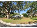 Spacious front yard with home, stone details, and mature trees at 4404 Hickory Branch Ct, Brandon, FL 33511