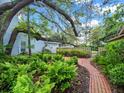 Lush garden with brick pathway and privacy fence at 4610 Westford Cir, Tampa, FL 33618