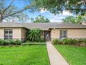 Inviting single-story home with lush landscaping leading to a welcoming entrance at 4610 Westford Cir, Tampa, FL 33618