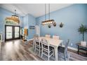 Bright dining room with stylish lighting, modern decor, and double-door access to front porch at 4736 Stonebriar Dr, Oldsmar, FL 34677