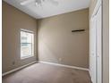 Empty bedroom with neutral walls, carpet flooring, ceiling fan, and closet, ready for personalization at 509 Delwood Breck St, Ruskin, FL 33570