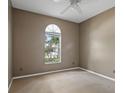 This carpeted bedroom with a unique window offers a blank canvas for your personal design at 509 Delwood Breck St, Ruskin, FL 33570
