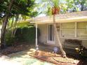 Inviting front porch with seating and a decorative pelican statue, framed by lush greenery at 5468 26Th N Ave, St Petersburg, FL 33710