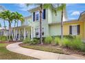 Two-story home with lush, mature landscaping, walkway, and a welcoming front porch at 5518 Luminar Pointe Ln, Apollo Beach, FL 33572