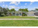 Inviting home with a lush green lawn, manicured landscaping, and a charming facade at 759 Lantana Ave, Clearwater Beach, FL 33767