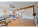 Open floor plan with hardwood floors, white walls, and a structural beam, creating a bright and airy living space at 759 Lantana Ave, Clearwater Beach, FL 33767