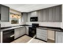 Updated kitchen with sleek, gray cabinetry, modern appliances, and subway tile backsplash at 915 S Miller Rd, Valrico, FL 33594