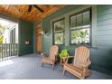 Spacious front porch with wood ceiling and chairs provides relaxing outdoor space at 101 E Lambright St, Tampa, FL 33604