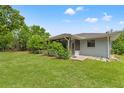 The expansive backyard with lush green grass and mature trees for shade at 10237 Carrin Rd, Spring Hill, FL 34608