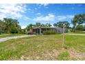 Charming single-story home with lawn, driveway, and a screened in porch at 11896 104Th Ln, Largo, FL 33773