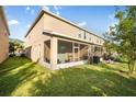 This home features a screened in patio, lush green grass, and a view of the home's exterior at 1218 Grantham Dr, Sarasota, FL 34234