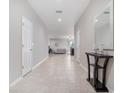 Bright foyer featuring tile floors, neutral paint, and a view to the living room at 1218 Grantham Dr, Sarasota, FL 34234