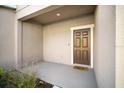 Welcoming covered front porch with a brown front door and neutral exterior paint at 1218 Grantham Dr, Sarasota, FL 34234