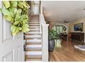 Warm, naturally lit entryway with hardwood floors and staircase leading to the second floor at 12472 Country White Cir, Tampa, FL 33635