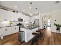 Modern kitchen featuring white cabinets, granite countertops, a large island, and stainless steel appliances at 12643 Shetland Walk Dr, Lithia, FL 33547