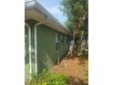 Side exterior showcasing green painted siding with white trim at 159 6Th Nw St, Largo, FL 33770