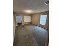 Bright living room with neutral walls, carpet, and good natural lighting at 159 6Th Nw St, Largo, FL 33770