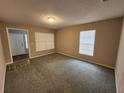 Spacious carpeted living room with natural light from two windows at 159 6Th Nw St, Largo, FL 33770