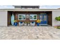 Charming entrance featuring comfortable seating, rustic wood accents, and a beautifully paved driveway at 16106 6Th E St, Redington Beach, FL 33708