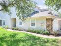 The side of the house features a well-maintained lawn, a garage with stone accents, and manicured bushes at 19232 Stone Hedge Dr, Tampa, FL 33647