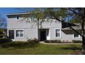 Inviting townhome with manicured lawn, vibrant flower bed, and neat shrubbery framing a pathway to the entrance at 19232 Stone Hedge Dr, Tampa, FL 33647