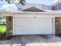 A single-car garage with a white door and stone accents complementing the home's exterior at 19232 Stone Hedge Dr, Tampa, FL 33647