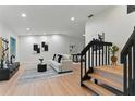 Bright living room boasts hardwood floors, contemporary decor, and ample natural light, creating a welcoming atmosphere at 2272 Adam Ct, Palm Harbor, FL 34683