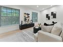 Stylish living room featuring modern decor, large windows, and a cozy seating area, ideal for relaxing or entertaining at 2272 Adam Ct, Palm Harbor, FL 34683