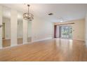 Bright living room featuring wood laminate floors, ceiling fan, and sliding glass doors at 2465 Northside Dr # 605, Clearwater, FL 33761