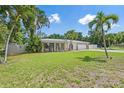 Landscaped front yard with freshly mowed grass featuring a charming one-story home, white picket fence, and blue accents at 2820 Whitney Rd, Clearwater, FL 33760