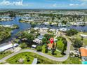 Aerial view of a waterfront neighborhood with canals and private boat docks for easy water access at 301 Carlyle Blvd, Ruskin, FL 33570