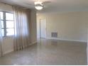 Bright living room with polished terrazzo floors and sheer curtains, enhancing natural light at 3014 58Th S St, Gulfport, FL 33707