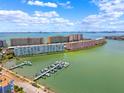 Stunning aerial view of waterfront condos with boat docks, offering a luxurious coastal lifestyle at 3018 59Th S St # 405, Gulfport, FL 33707