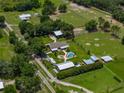 A property featuring a home, RV, barn, pool and outdoor entertainment area surrounded by green space at 3412 Ace Ln, Dover, FL 33527