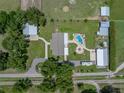 A birds-eye view of the property featuring a pool, barn, storage shed and home at 3412 Ace Ln, Dover, FL 33527