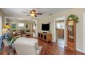 Spacious living room featuring hardwood floors, a ceiling fan, and a view of the kitchen at 4206 W Palmira Ave, Tampa, FL 33629