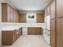 Modern kitchen with wood cabinets, white countertops, stainless steel appliances, and a wine refrigerator at 4616 W Estrella St, Tampa, FL 33629