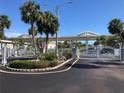 Gated community entrance with well-maintained landscaping and palm trees at 4851 W Gandy Blvd # B2L10, Tampa, FL 33611