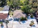Charming single-story home featuring an expansive driveway, lush landscaping, and a serene water view at 5240 31St S Ave, Gulfport, FL 33707