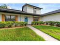 Inviting home exterior with a vibrant blue door and manicured landscaping enhancing curb appeal at 5303 Glen Harwell Rd, Plant City, FL 33566