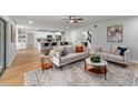 Bright living room with modern furniture, an open floor plan, and hardwood floors for a cozy atmosphere at 5303 Glen Harwell Rd, Plant City, FL 33566